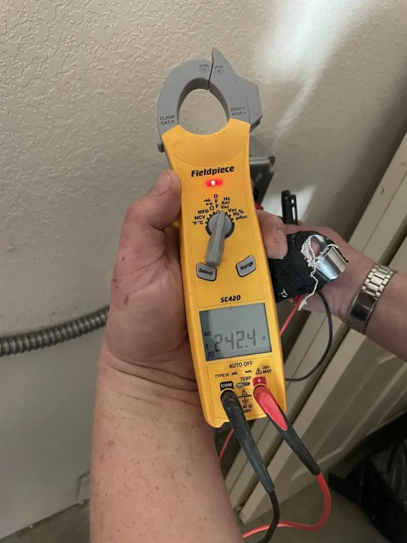 Voltage testing with clamp meter during Electrical Installation Services in Dundalk